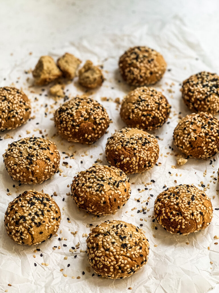 12 Sesame covered cookies on a tray
